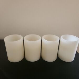 4 flameless wax pillar candles.  Battery powered unscented